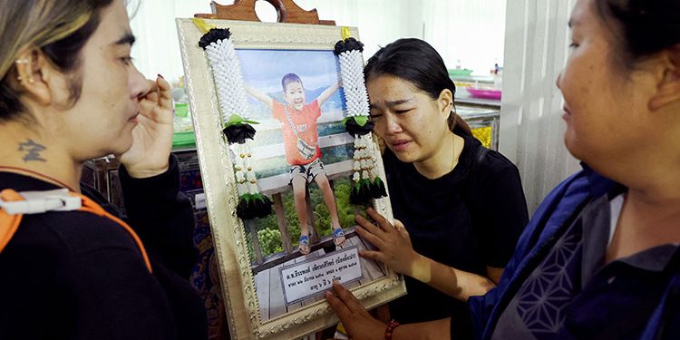 Flowers and toys at funeral for Thai school bus fire victims