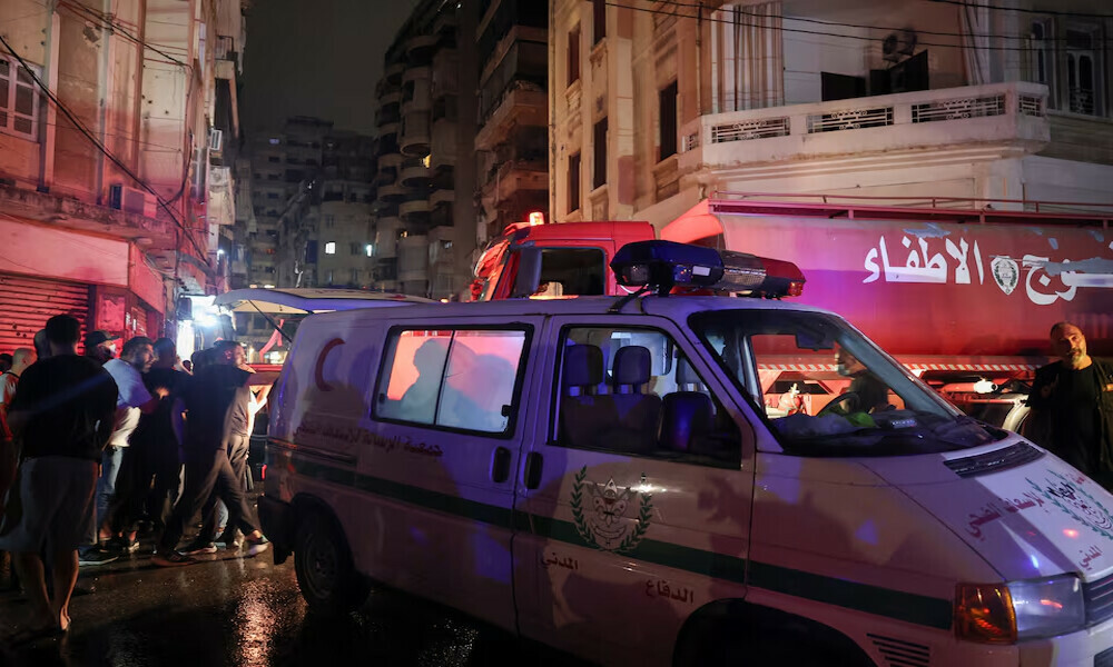  People stand near rescue vehicles at the site of an Israeli air strike, amid ongoing hostilities between Hezbollah and Israeli forces, in Ras Al- Nabaa, in Beirut, Lebanon. Photo: Reuters 