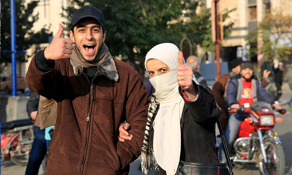 People celebrate in the central city of Homs on December 8, 2024, after rebel forces entered Syria’s third city overnight. Photo: AFP