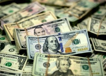 Dollar follows yields higher on strong US data