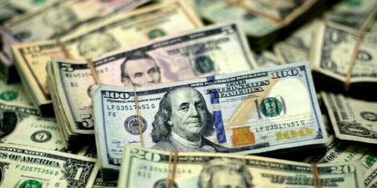 Dollar follows yields higher on strong US data