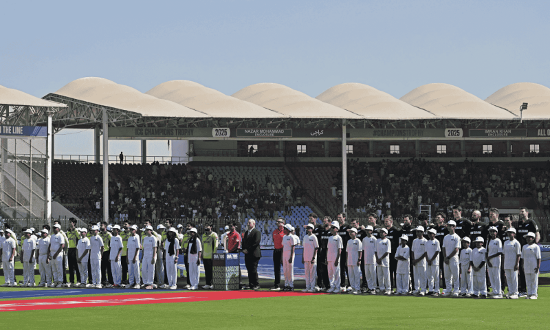 Pakistan’s (L) and New Zealand’s (R) players stand for the national anthem before the start of the ICC Champions Trophy one-day international (ODI) cricket match between Pakistan and New Zealand at the National Stadium in Karachi on February 19. — AFP