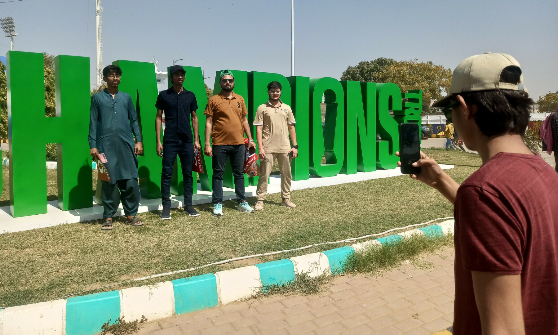  Cricket fans pose outside National Stadium as a Pakistan-New Zealand match is underway in Karachi on Feb 19, 2025. — Abyan Amir 