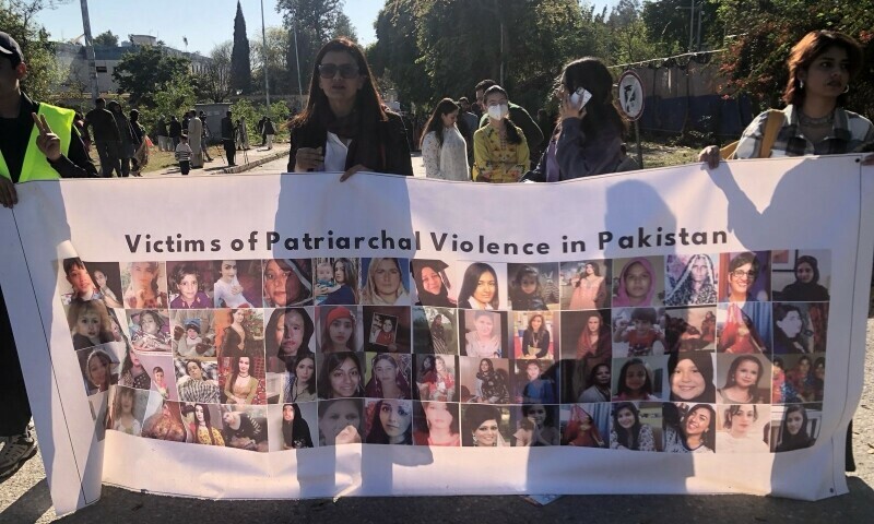  Marchers carry a banner during the 2025 Aurat March in Islamabad on March 8. — Photo by author 