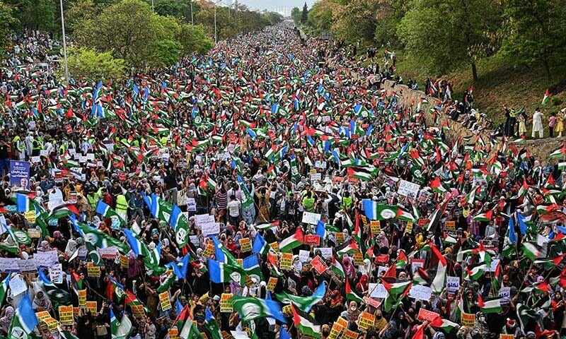 Supporters of the Jamaat-i-Islaami (JI) party hold Palestinian flags during a protest in Islamabad on April 20. — AFP