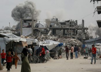 Gaza air strikes kill 94 as manhunt unfolds in West Bank