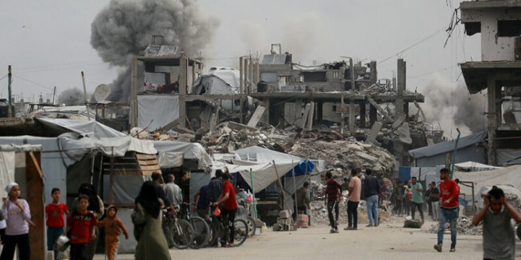 Gaza air strikes kill 94 as manhunt unfolds in West Bank