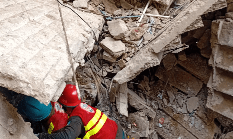  Rescue officials at the site of a building collapse in Karachi’s Lyari area on July 4, 2025. — screengrab from video via Imtiaz Ali 