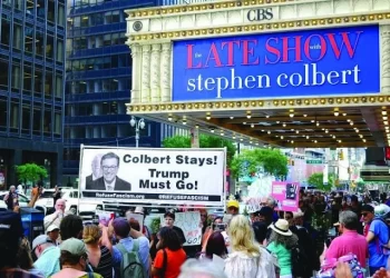 protesters hold placards supporting colbert photo afp