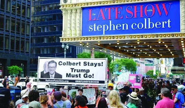protesters hold placards supporting colbert photo afp