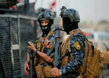Iraqi police clash with paramilitary fighters who stormed govt building
