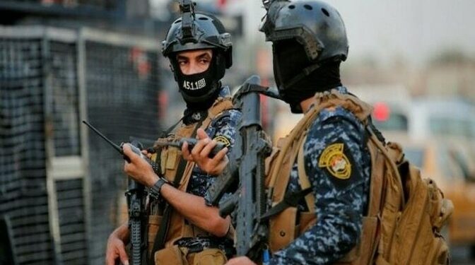 Iraqi police clash with paramilitary fighters who stormed govt building