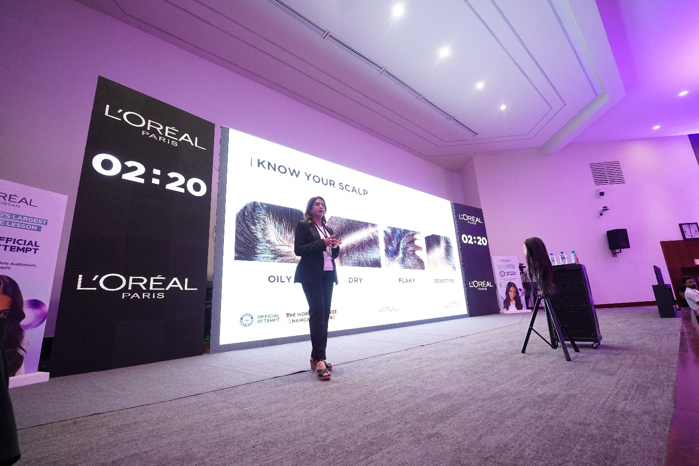 A person speaking in front of a large screen

AI-generated content may be incorrect.