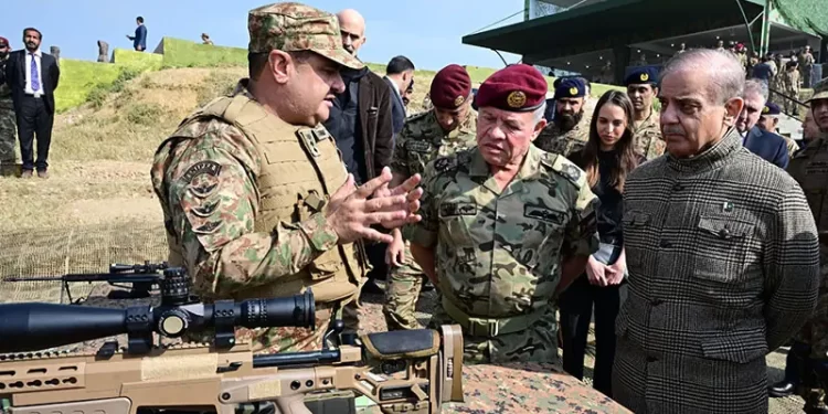 Jordan’s King Abdullah II, accompanied by Prime Minister Shehbaz Sharif, is shown a sniper rifle at the Tilla Fields firing range near Jhelum on November 16. — Photo courtesy ISPR