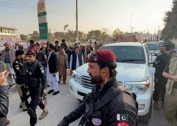 Police commandos escort a vehicle carrying KP Chief Minister Sohail Afridi near Adiala Jail in Rawalpindi on November 27. — Reuters