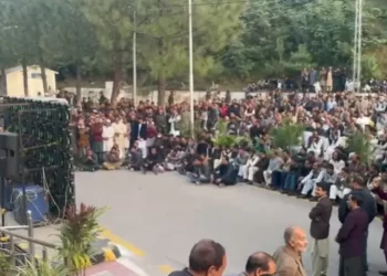 People view proceedings of the Azad Jammu and Kashmir Assembly live on big screen installed outside the assembly’s building on Nov 17. — Photo by Tariq Naqash