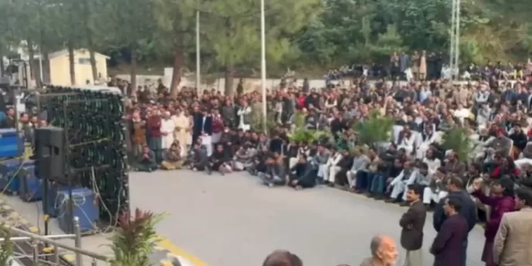 People view proceedings of the Azad Jammu and Kashmir Assembly live on big screen installed outside the assembly’s building on Nov 17. — Photo by Tariq Naqash