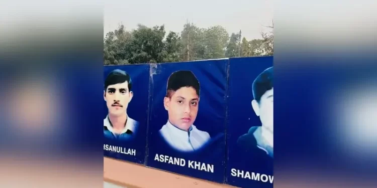 A banner shows the portraits and names of victims of the 2014 Army Publis School massacre, in Peshawar on December 15. — Photo via author