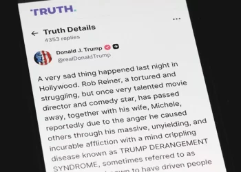 a phone shows us president donald trump s truth social post on the death of actor and director rob reiner in washington dc photo afp