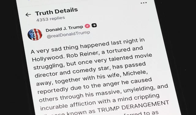 a phone shows us president donald trump s truth social post on the death of actor and director rob reiner in washington dc photo afp