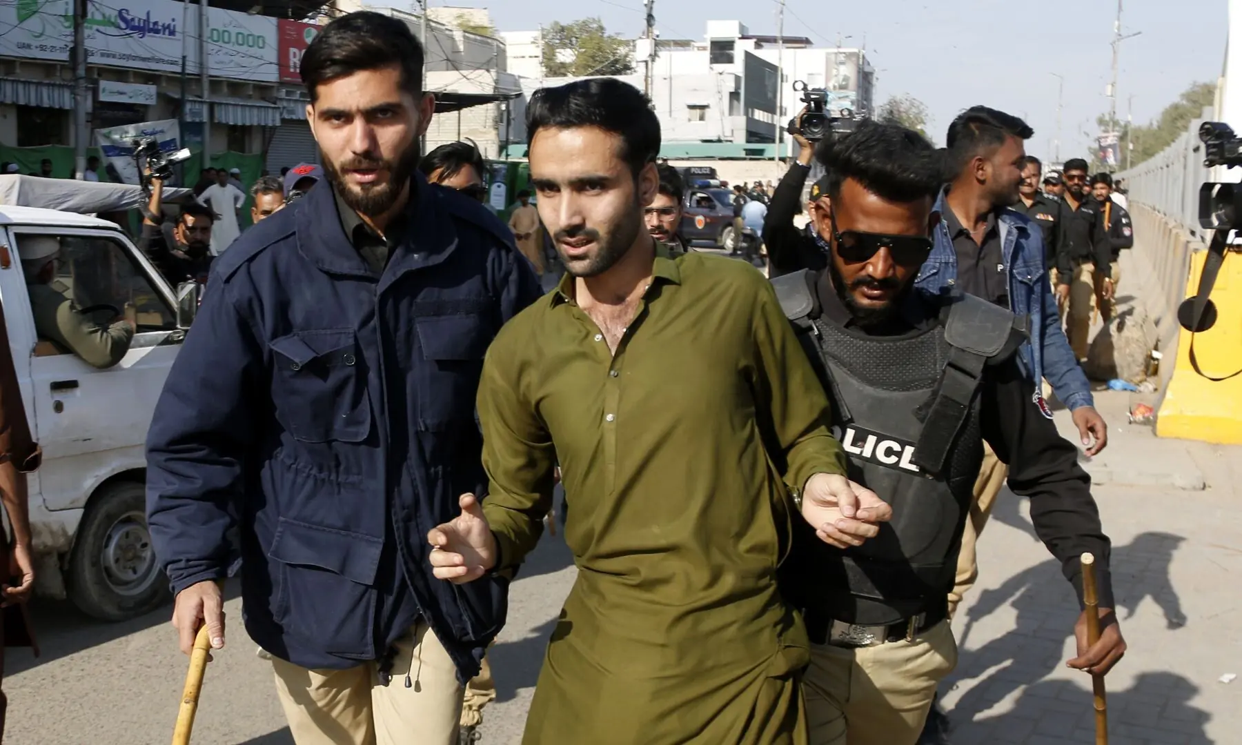 Police detain a PTI supporter gathered near Numaish Chowrangi, Karachi ahead of a PTI rally, on Jan 11, 2026. &mdash; Shakil Adil/White Star