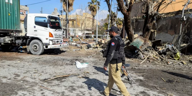 A police officer walks past damage at the site, after militant attacks, in Quetta on Feb 1, 2026. — Reuters